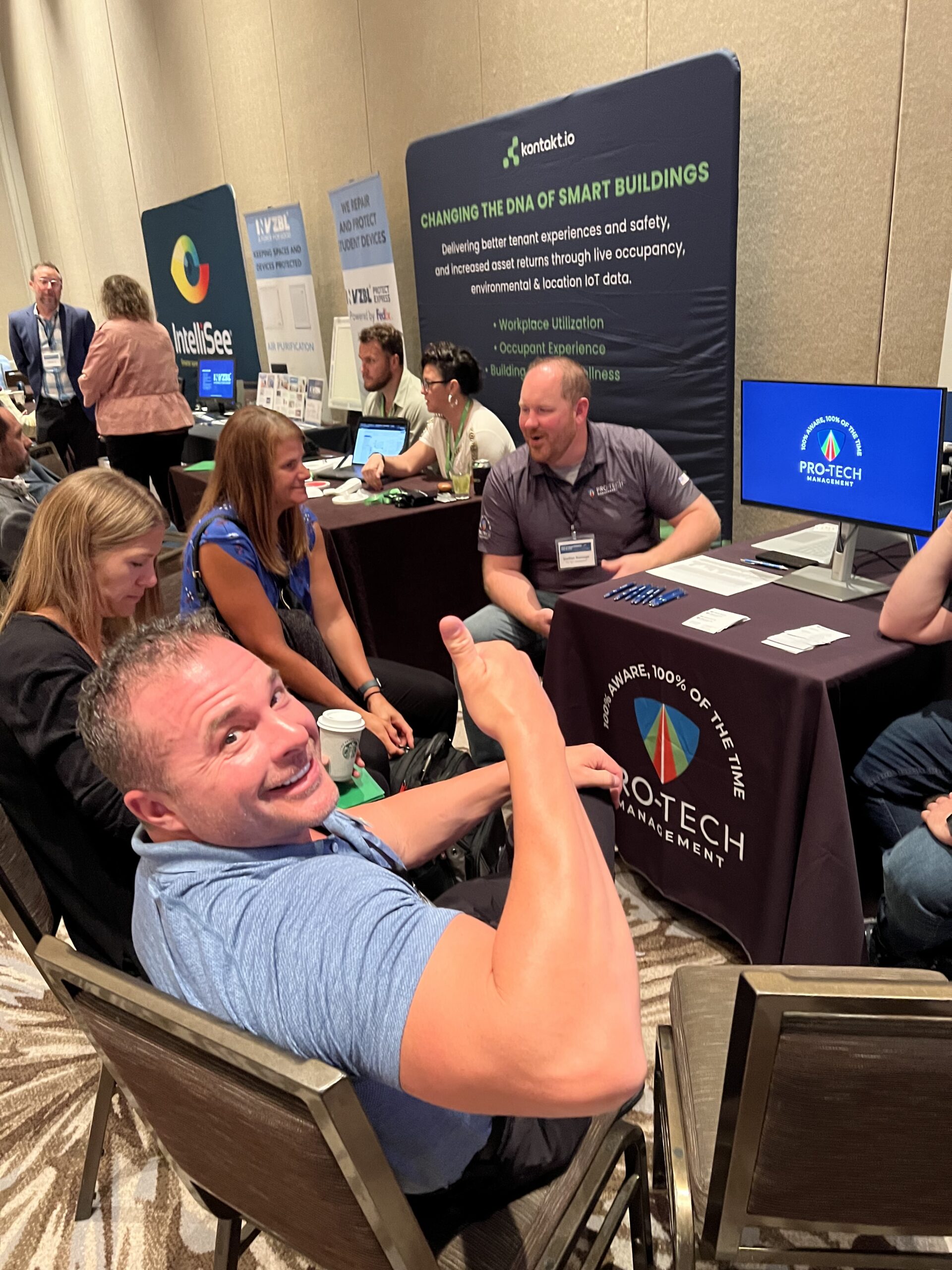 man giving thumbs up while presented with technology
