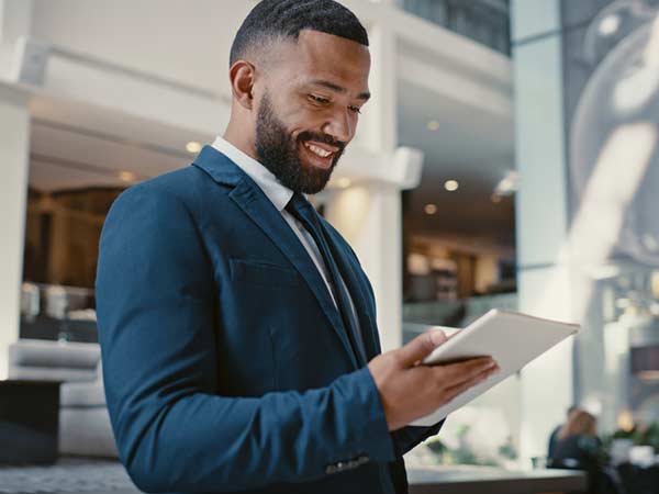 Businessman, digital tablet or strategy planning in hotel conference lobby or airport travel lounge.